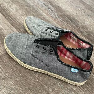 TOMS black chambray with floral design slip-ons